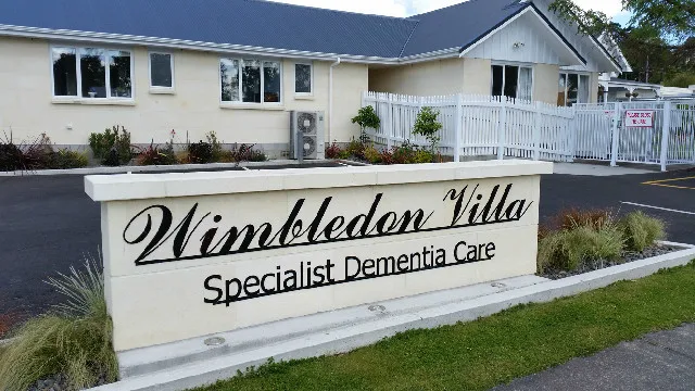 The 'Wimbledon Villa — Specialist Dementia Care' entry sign in front of the secure wing.