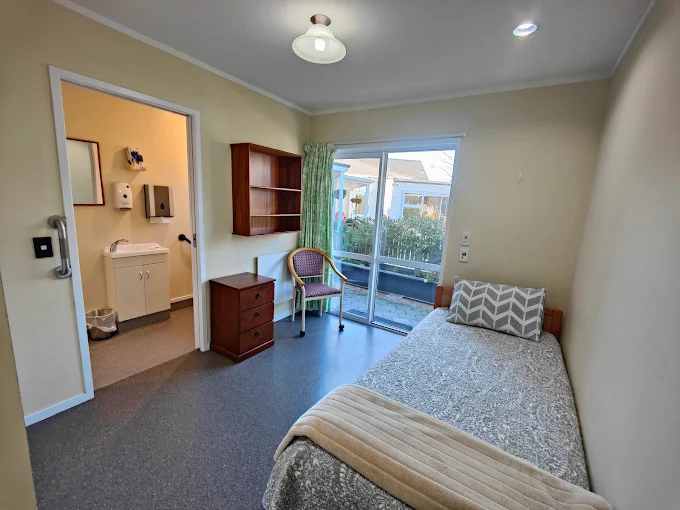 A warm, sunlit resident bedroom