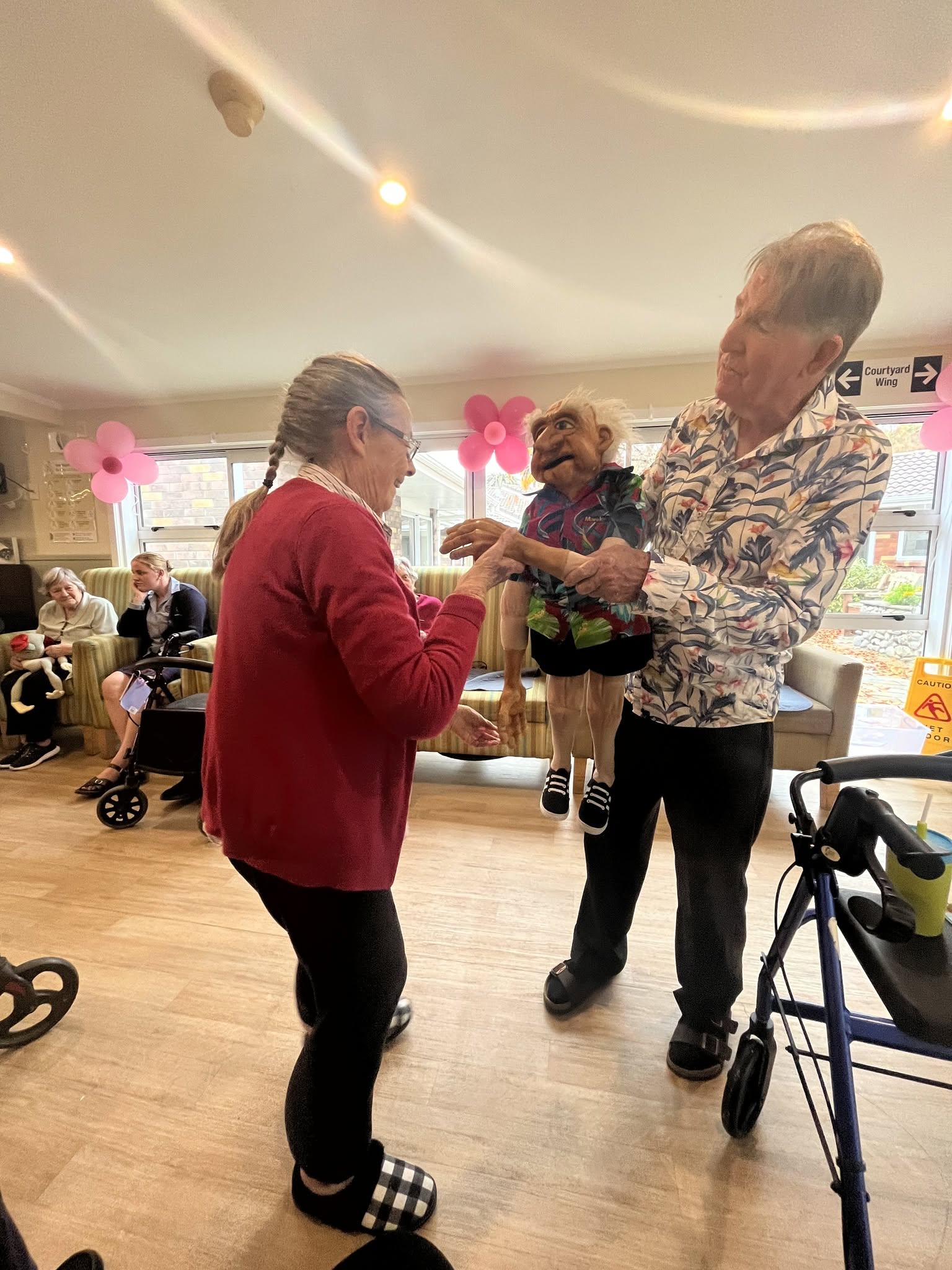 Residents sharing a moment of laughter during an afternoon activity at Wimbledon Villa.